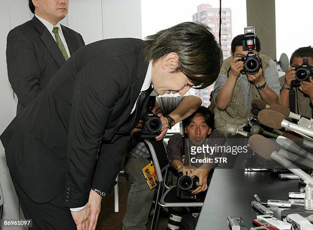 Disgraced Japanese music producer Tetsuya Komuro, one of the most successful in Japan's pop music history who now is accused of fraud, bows his head...