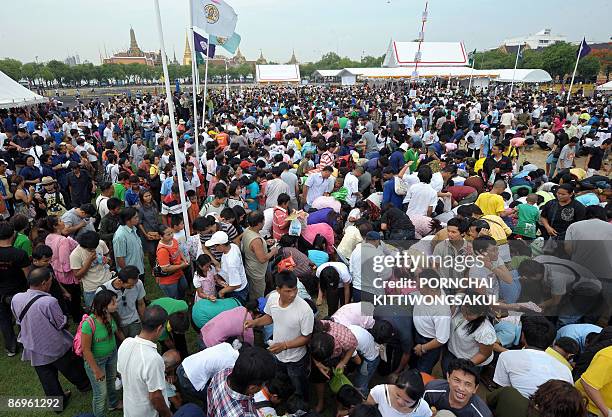 Villagers battle for rice seeds on May 11, 2009 during the annual 'Royal Ploughing Ceremony' at Sanam Luang in Bangkok. Local press have reported...