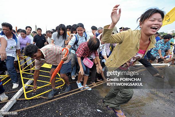 Villagers battle for rice seeds on May 11, 2009 during the annual 'Royal Ploughing Ceremony' at Sanam Luang in Bangkok. Local press have reported...