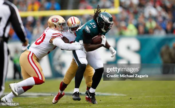 Brock Coyle and Leon Hall of the San Francisco 49ers tackle LeGarrette Blount of the Philadelphia Eagles during the game at Lincoln Financial Field...