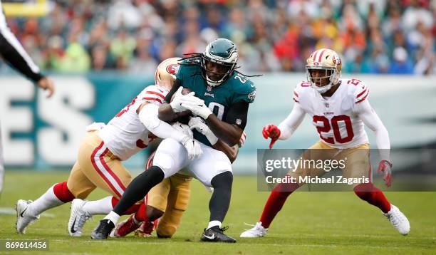 Brock Coyle and Leon Hall of the San Francisco 49ers tackle LeGarrette Blount of the Philadelphia Eagles during the game at Lincoln Financial Field...