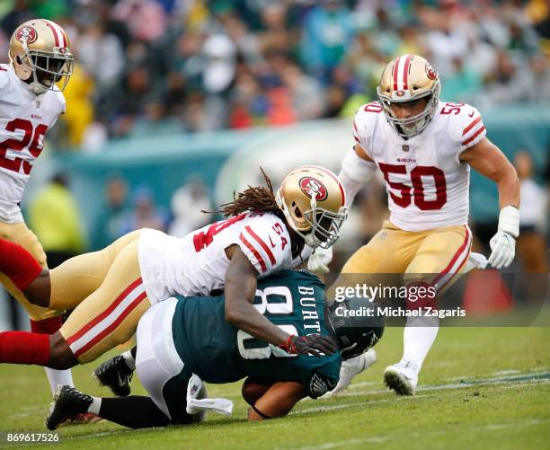 Ray-Ray Armstrong of the San Francisco 49ers tackles Trey Burton of the Philadelphia Eagles during the game at Lincoln Financial Field on October 29,...