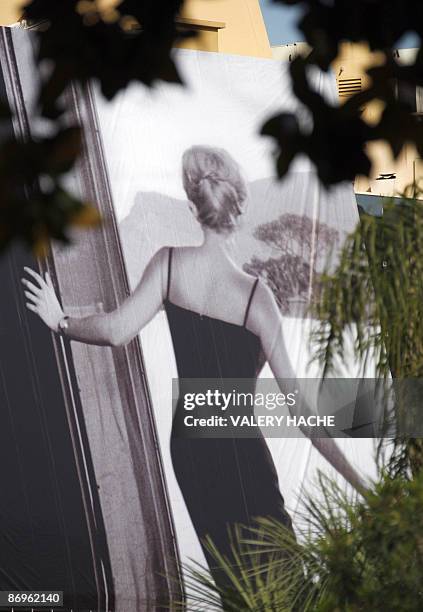 People set up the official poster of the Cannes' film festival 62nd edition on the Festivals' palace facade on May 11, 2009 in Cannes, south eastern...