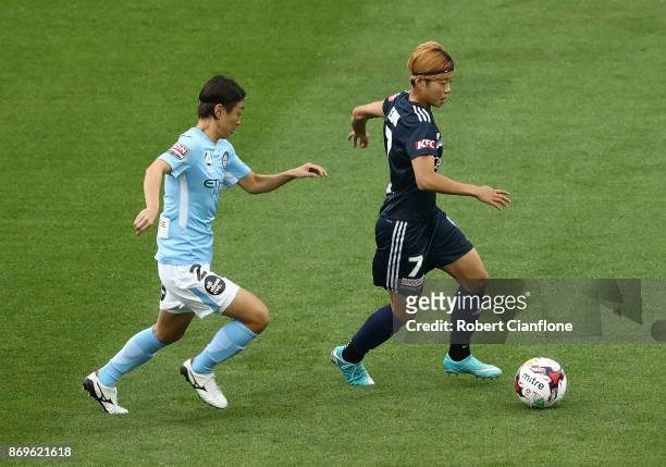 Jeon Ga Eul of the Victory is chased by Yukari Kinga of Melbourne City during the round two W-League match between Melbourne City FC and Melbourne...