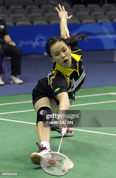Wong Mew Choo of Malaysia returns the shuttlecock to South Korea's Hwang Hye Youn during their women's singles match in the preliminary matches of...