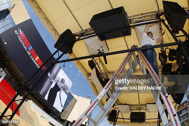 People are at work, on May 11, 2009 in Cannes, south eastern France, in front of the Cannes' film festival palace prior to the opening of the 62nd...