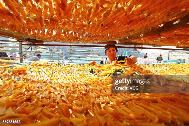 Farmers spread sweet potatoes to dry during the harvest season at Shanting District on November 2, 2017 in Zaozhuang, Shandong Province of China....