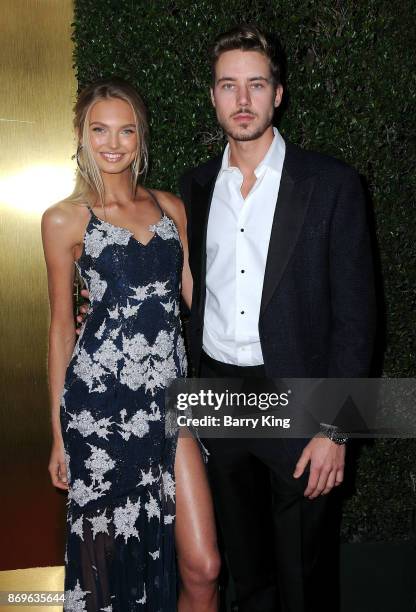 Model Romee Strijd and actor Cameron Fuller attend #REVOLVEawards at DREAM Hollywood on November 2, 2017 in Hollywood, California.