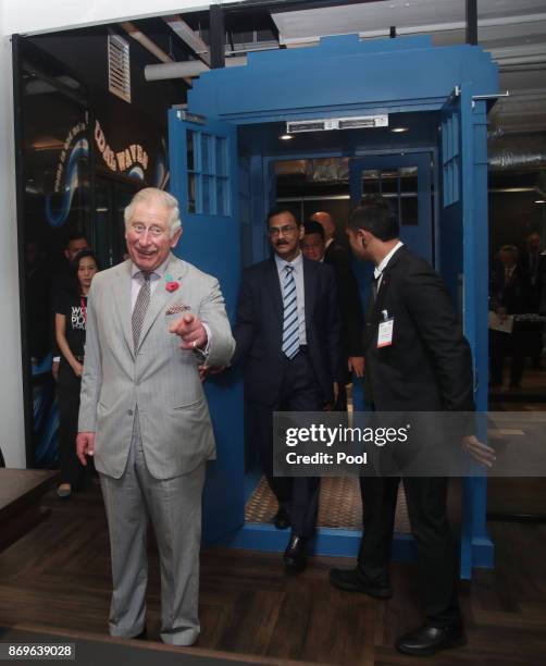 Prince Charles, The Prince of Wales enters through a door shaped in the style of Dr Who's Tardis during his visit to Worq Co-working space for Young...