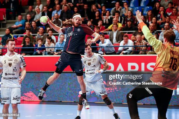 Mikkel Hansen of Paris Saint Germain is shooting the ball against William Annotel of Dunkerque Handball during the Lidl Star Ligue match between...