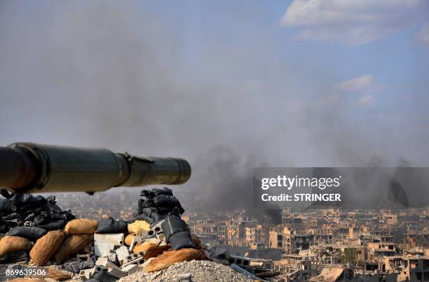 Smoke billows from the eastern city of Deir Ezzor during an operation by Syrian government forces against Islamic State group jihadists on November...