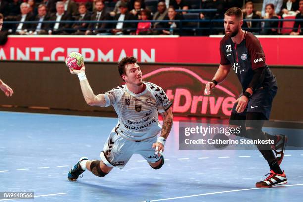 Alexandro Pozzer of Dunkerque Handball is shooting the ball against Luka Karabatic of Paris Saint Germain during the Lidl Star Ligue match between...