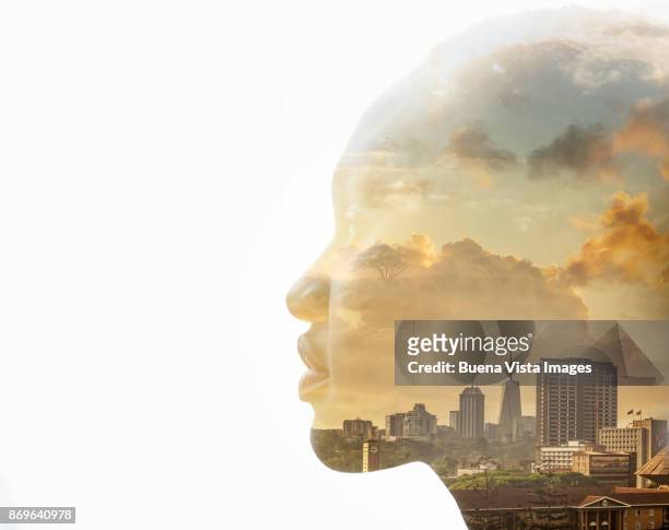 african woman over sunset and city skyline - part of a series foto e immagini stock
