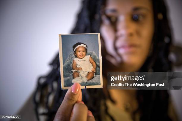 Brandy Johnson Billie holds a photograph of her daughter, Ashanti, a 19-year-old college student, who disappeared going to work. Ashanti was later...