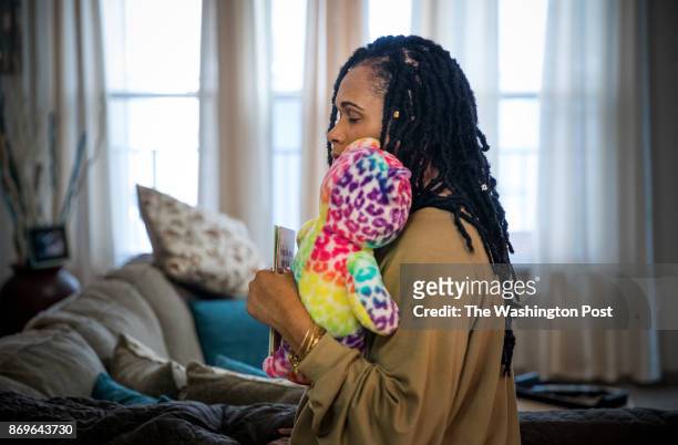 Brandy Johnson Billie, holds one of her daughter Ashanti's favorite teddy bears, in her apartment in Oxon Hill, Maryland. Ashanti, a 19-year-old...