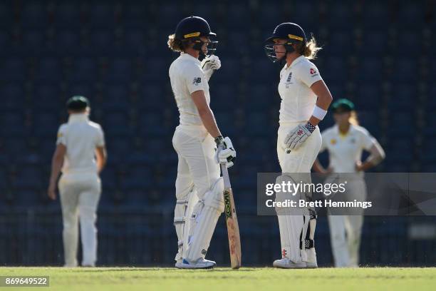 Lauren Winfield of England and Sarah Taylor of England speak between overs during day one of the Women's Tour match between England and the Cricket...