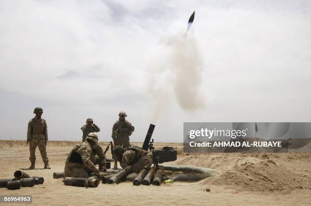 120mm mortar is fired during a training operation in at a desert range some 40 kms south of the town of Latifiyah, on May 11 2009. Iraqi soldiers...