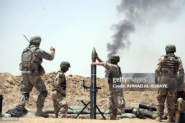 Soldier gives the thumbs-up as a 120mm mortar is loaded during a training operation at a desert range some 40 kms south of the town of Latifiyah, on...