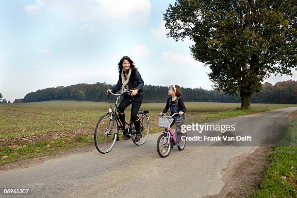 family cycling in fall - bicycle daughter stock-fotos und bilder