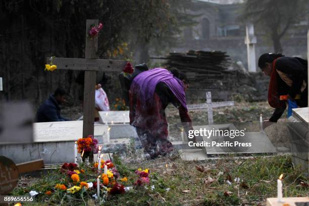 Christian devotees light candles during the commemoration of All Souls Day in a local cemetery in Srinagar the summer capital of Indian controlled...