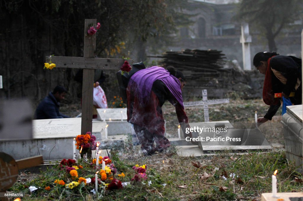 Christian devotees light candles during the commemoration of...
