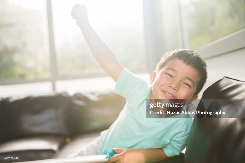 Mixed race kid making a happy face.