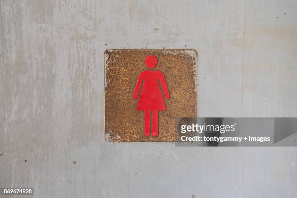 female sign on toilet door. - woman toilet stock-fotos und bilder