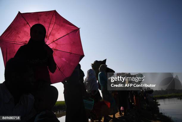 Rohingya Muslim refugees who were stranded after leaving Myanmar walk towards the Balukhali refugee camp after crossing the border in Bangladesh's...