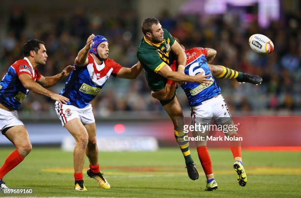 Wade Graham of Australia is up ended after offloading during the 2017 Rugby League World Cup match between Australian Kangaroos and France at...