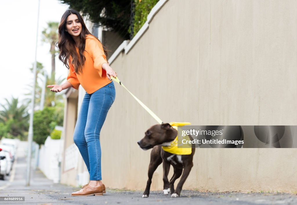 Young woman walking a dog