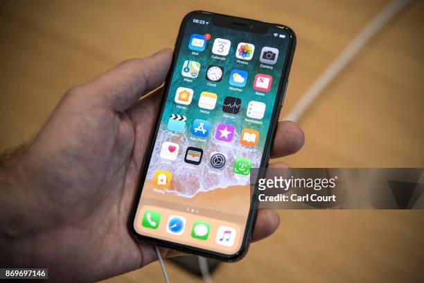 Customer poses with an iPhone X as he purchases one upon its release in the U.K, on November 3, 2017 in London, England. The iPhone X is positioned...