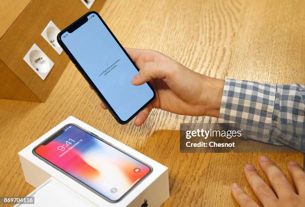 Customer set up an Apple iPhone X, the new model of Apple smartphone at the Apple Store Saint-Germain on November 3, 2017 in Paris, France. Apple's...