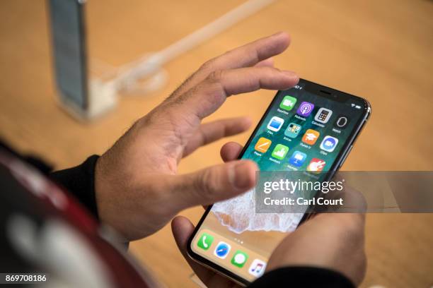 Customer views the iPhone X upon its release in the U.K on November 3, 2017 in London, England. The iPhone X is positioned as a high-end, model...