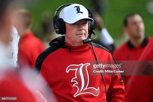 Head coach Bobby Petrino of the Louisville Cardinals walks the sidelines late in the fourth quarter of the Cardinals' football game against the Wake...