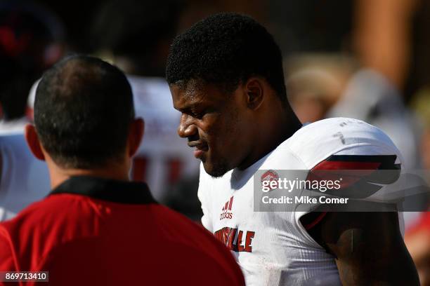 Quarterback Lamar Jackson of the Louisville Cardinals talks with a member of the Cardinals' staff during the fourth quarter of the Cardinals'...