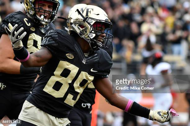 Wide receiver Greg Dortch of the Wake Forest Demon Deacons celebrates after scoring a touchdown against the Louisville Cardinals late in the first...