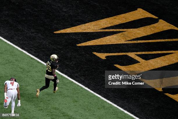 Wide receiver Greg Dortch of the Wake Forest Demon Deacons runs in a touchdown reception against the Louisville Cardinals late in the second quarter...