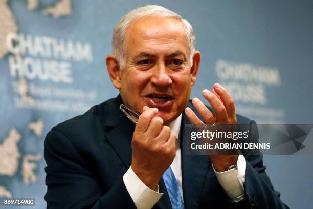 Israeli Prime Minister Benjamin Netanyahu gestures while giving a lecture regarding Israel's foreign policy priorities at Chatham House, The Royal...