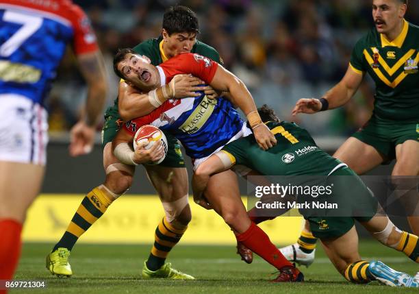 Benjamin Garcia of France is tackled during the 2017 Rugby League World Cup match between Australian Kangaroos and France at Canberra Stadium on...
