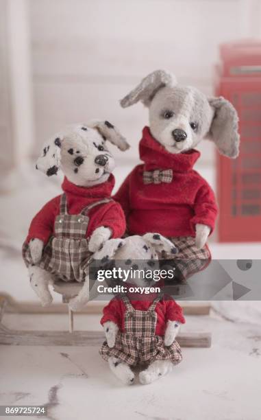 group of toys dogs with red sweaters and checked bib overalls - bib overalls stockfoto's en -beelden