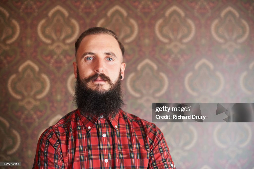 Portrait of hipster in his front room