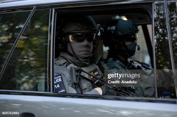 Armed anti-terrorism police watch over demonstrators as Israeli Prime Minister Benjamin Netanyahu arrives to Chatham House in London, England, where...