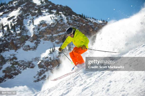 a man skiing on a sunny winter day - snowbird lodge stock pictures, royalty-free photos & images