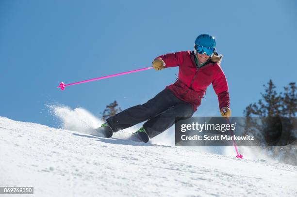 a woman skiing on a sunny winter day - snowbird lodge stock pictures, royalty-free photos & images