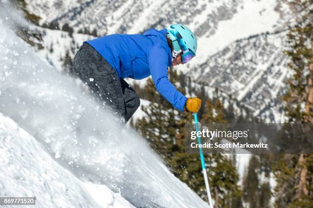 a woman skiing on a sunny winter day - snowbird lodge stock pictures, royalty-free photos & images