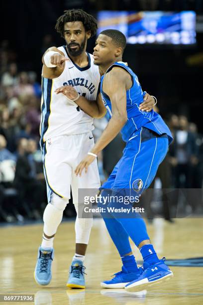 Mike Conley of the Memphis Grizzlies guards Dennis Smith Jr. #1 of the Dallas Mavericks at the FedEx Forum on October 26, 2017 in Memphis, Tennessee....