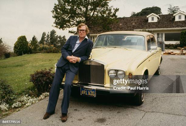 Actor Michael Caine leans on his Rolls Royce outside his Beverly Hills home . His home on Cielo Drive was on the same street that the Manson...