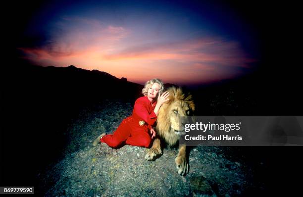 Actress Tipi Hedren, mother of Melanie Griffiths stands on a hill overlooking her Saugus Animal reserve with a full grown male lion. November 16,...