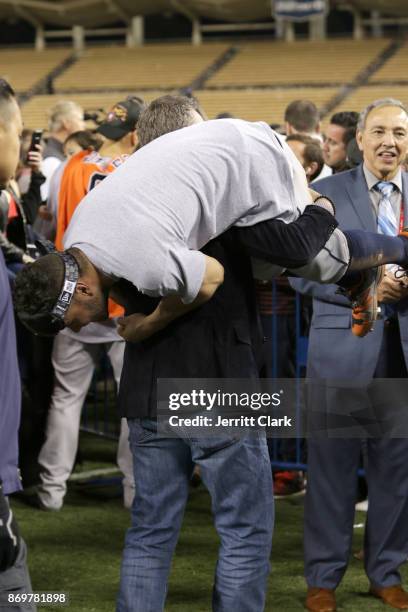 Jose Altuve of the Houston Astros and Hall of Famer Craig Biggio celebrate on the field after the Astros defeated the Los Angeles Dodgers in Game 7...