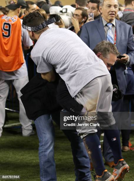 Jose Altuve of the Houston Astros and Hall of Famer Craig Biggio celebrate on the field after the Astros defeated the Los Angeles Dodgers in Game 7...